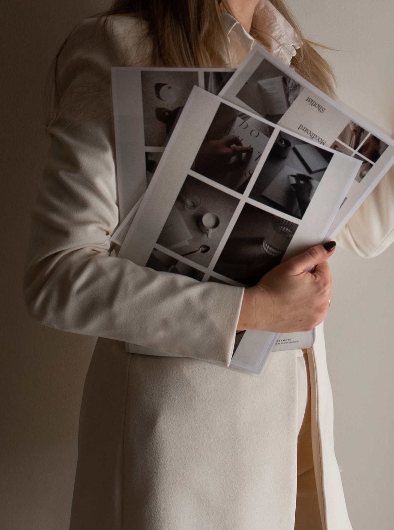 women holding a stack of images