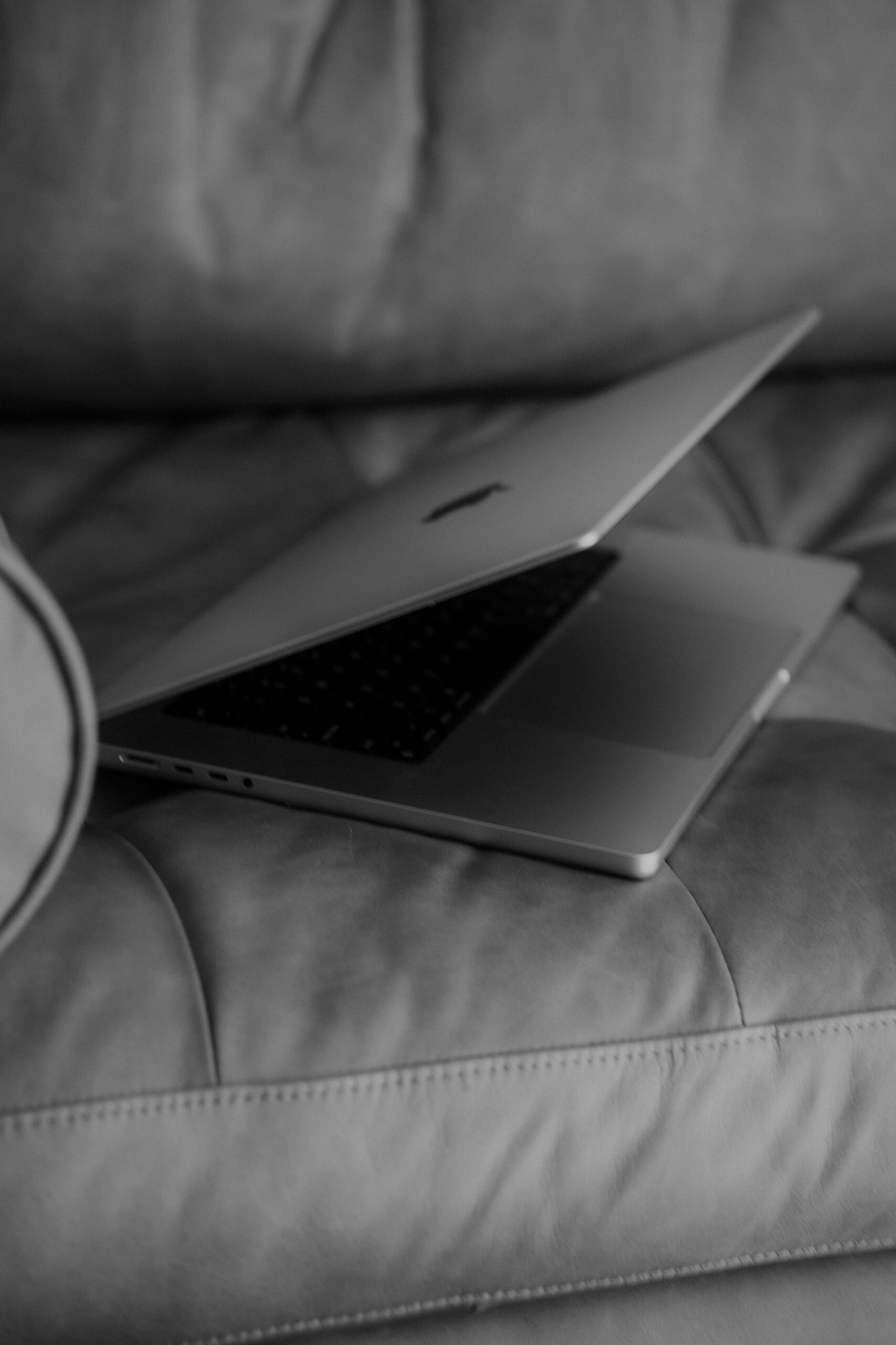 Laptop sitting on a sofa