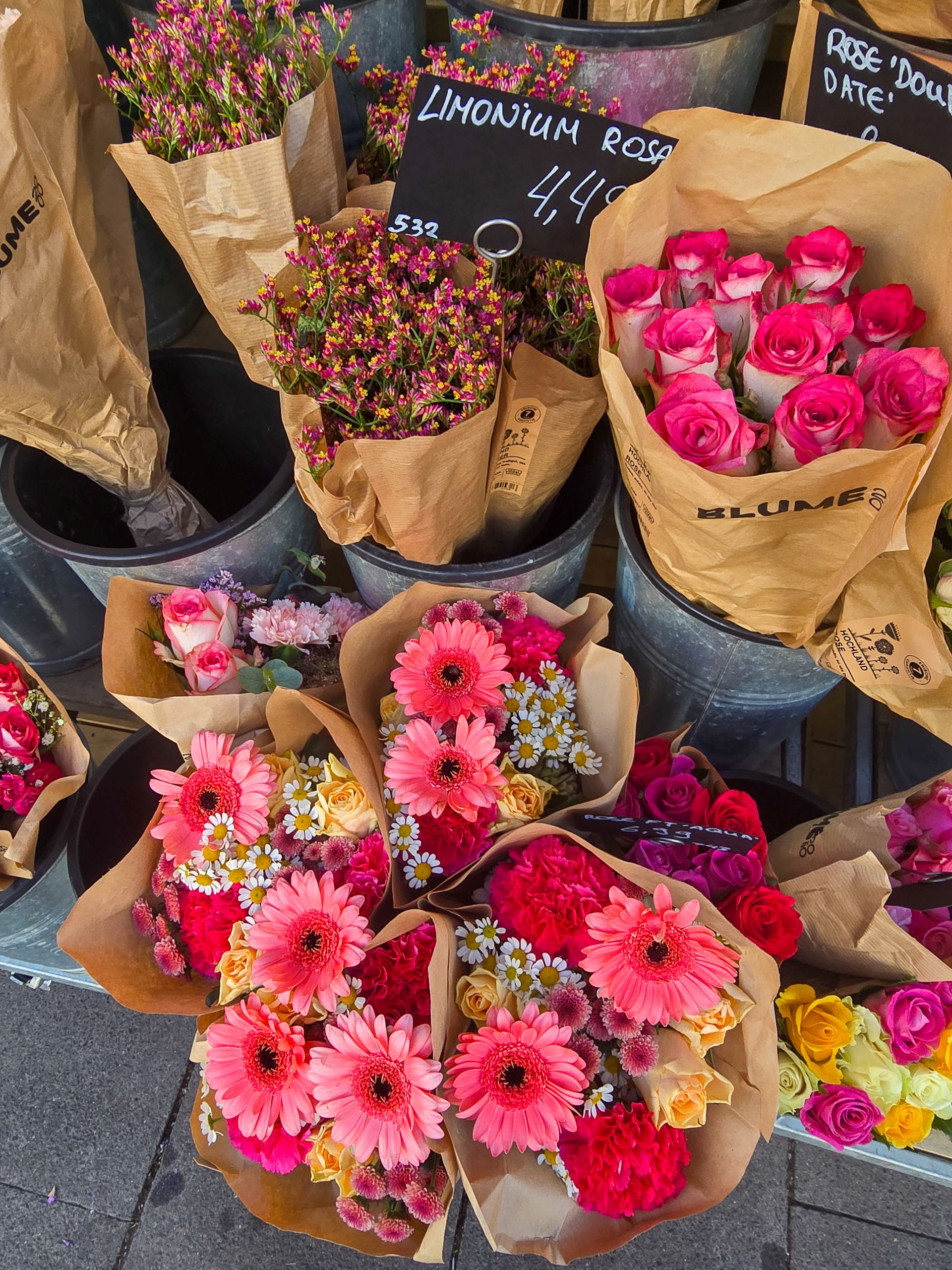 Pink and red flower bouquets for sale in buckets